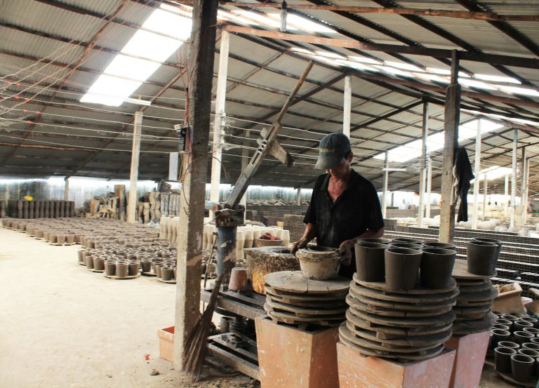Potter at work in a traditional pottery village in Vietnam