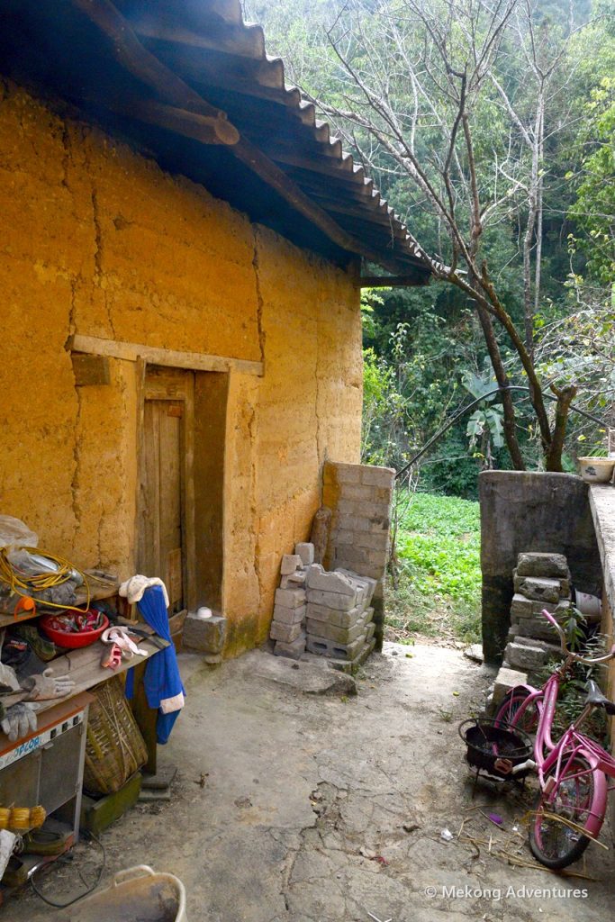 Doorway of a traditional earthen house in Then Pa village