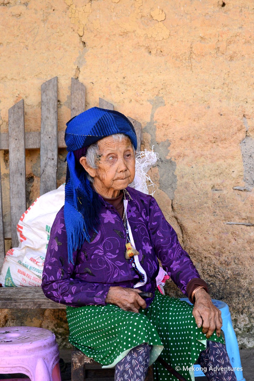 Elderly Hmong woman in a blue headscarf in Then Pa village