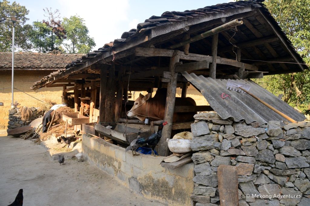 Wooden barn with stone walls in Then Pa village