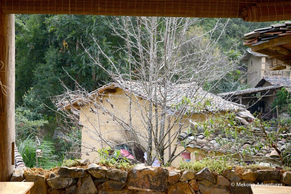 Earthen house behind a stone wall in Then Pa village, Ha Giang